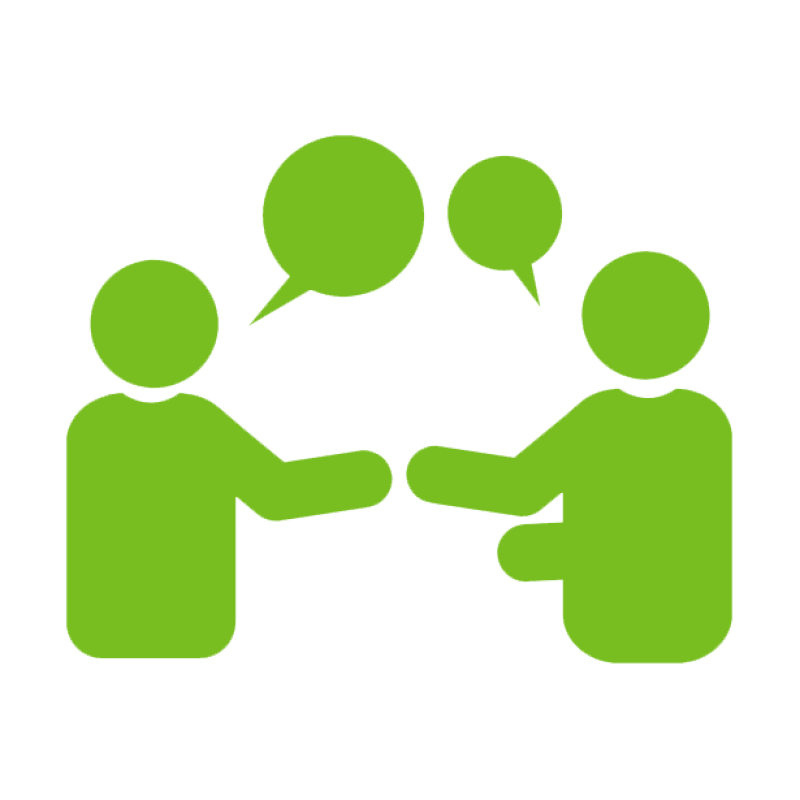 Green icon of two human figures facing each other with overlapping speech bubbles above them, representing conversation or coaching.